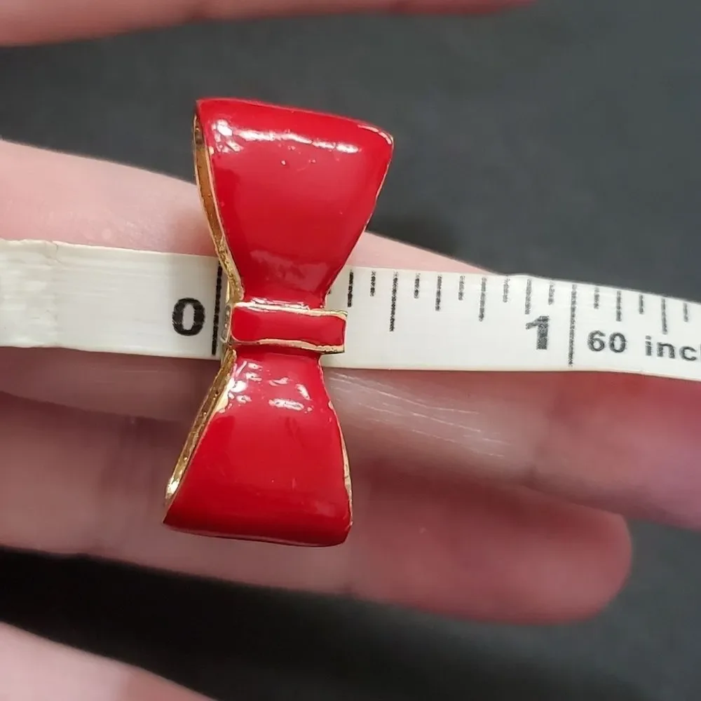 Gold tone red enamel bow ring currently a 7